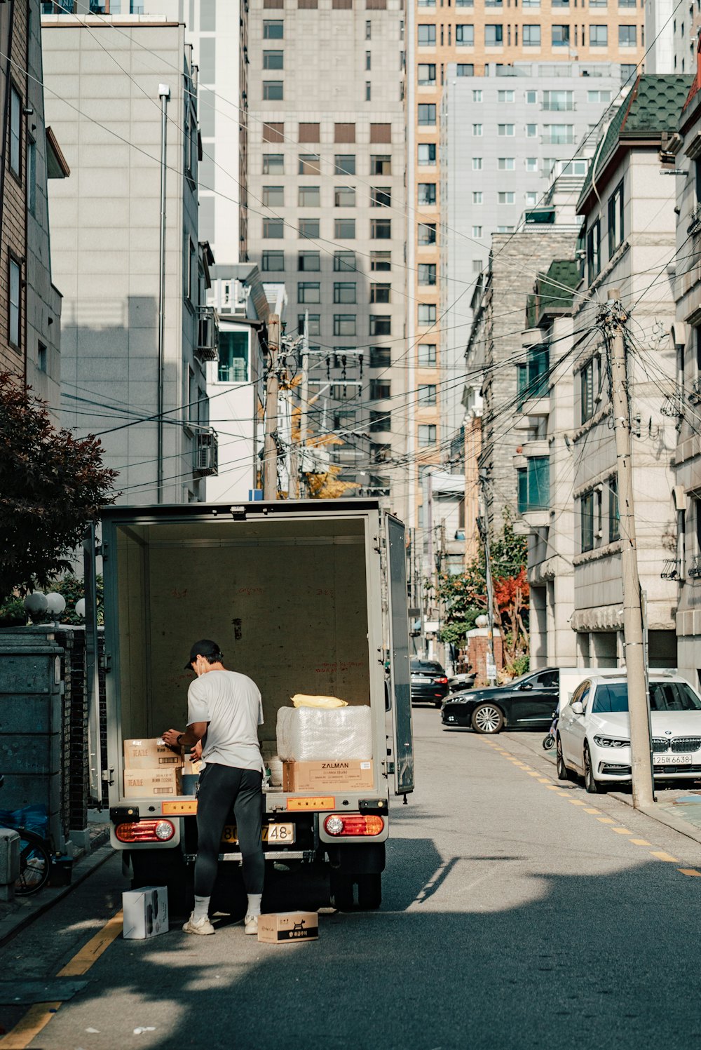 Driver unloading boxes from the back of a box truck